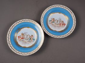 A pair of 19th century Sevres Chateau Fontainebleau soup plates with cherubs and monogram centres,