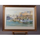 A watercolour coastal scene with cottages and small boats, 13" x 21", in gilt frame
