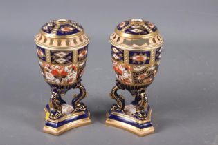 A pair of Davenport Imari decorated pot-pourri vases and covers (one repaired with losses), on