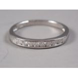 A white metal and diamond half eternity ring, stamped Plat, size Q