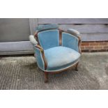 An Edwardian rosewood and inlaid tub-shape chair, upholstered in a blue velour, on square taper