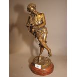 A bronze figure of a faun playing the bagpipes, on circular marble stand, 15" high overall