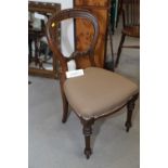 A set of six Victorian carved walnut balloon back dining chairs with stuffed over seats, on turned