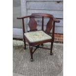 A Georgian oak provincial corner elbow chair with needlework seat, on turned and cabriole supports