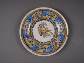 A 19th century Portuguese polychrome decorated faience shallow dish, maker's mark VM D, 13 3/4" dia