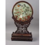 A Chinese circular jade and hardstone inlaid table screen, on carved and pierced stand, 21 1/2" high