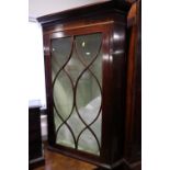 A 19th century mahogany and box line inlaid corner hanging cabinet with Gothic lattice glazed