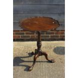 A mahogany pie crust tilt top occasional table, on turned column and tripod splay supports, 23"