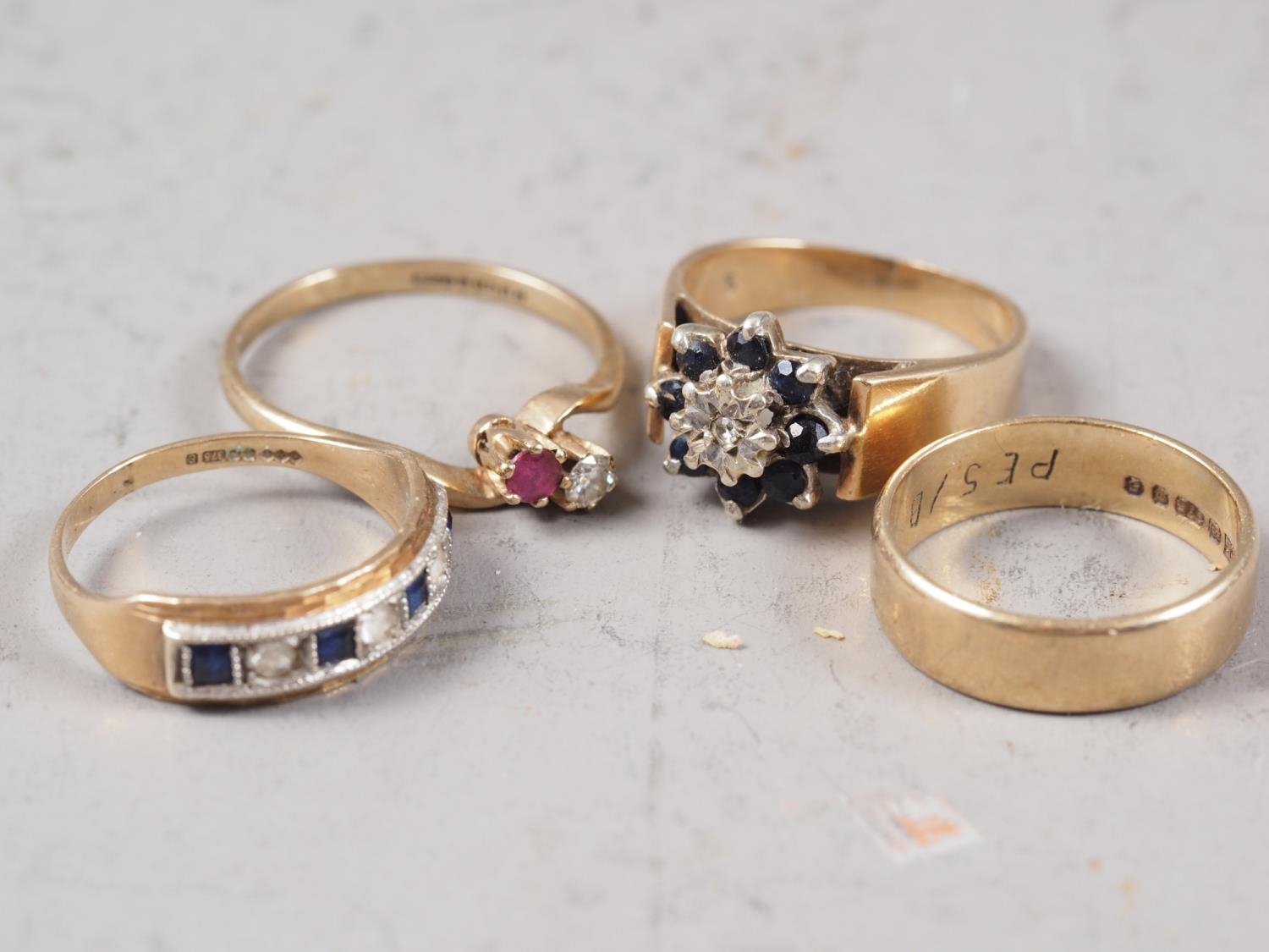 A 9ct gold, diamond and sapphire dress ring, size J, 1.9g, a 9ct gold, diamond and ruby crossover