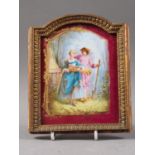 An early 19th century porcelain plaque with gardener figures, in gilt frame, 6 3/4" high