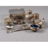 An engine turned silver cigarette box, a silver mounted scent bomb, a silver and cut glass salts jar