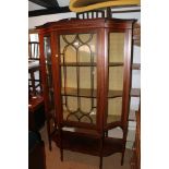 An Edwardian walnut and satinwood banded shape front display cabinet enclosed lattice glazed panel