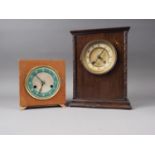 An early 20th century mahogany cased mantel clock with enamelled dial and Arabic numerals, 11" high,