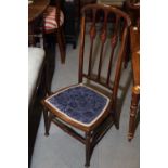 An Edwardian low seat vertical rail back chair and a Sutherland tea table