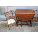 A dark oak drop leaf table, on barley twist supports, 29 3/4" wide x 14 1/2" deep x 28 1/4" high,