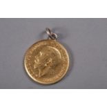 A gold sovereign, dated 1911 (hard mounted)