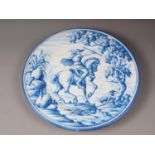 A faience charger with blue and white horse and rider decoration, 16" dia