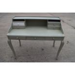 A painted shape top dressing table, fitted four drawers and recess over three drawers, on cabriole