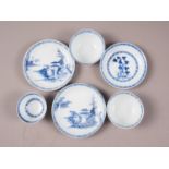 Three Nanking cargo tea bowls and saucers with blue and white landscape decoration, and "The Nanking