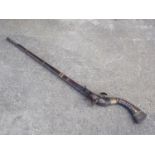 A Jezail flintlock musket with scroll etched barrel, 44 3/4" long, and white metal inset stock,