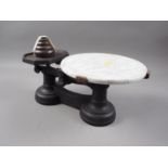 A cast iron cheese balance with marble effect top and weights
