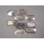 Eight assorted silver plated bottle tickets/decanter labels and a similar enamelled example