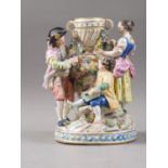 A 19th century Continental table centre group, figures garlanding an urn, on circular base, 7 3/4"