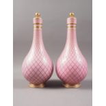 A pair of Sevres style porcelain bottle vases and covers with all-over lattice decoration on a