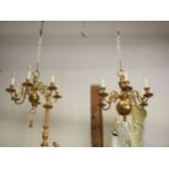 A gilt metal six-light chandelier, 22 1/2" high overall, and another similar smaller chandelier, 17"