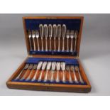 A set of twelve silver plated fish knives and forks, in oak canteen, and a cut glass and plated