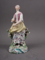 An 18th century Derby figure of a girl, 7" high (damages)
