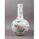 A Chinese porcelain bulbous vase with enamelled panels of figures in landscapes on a floral strewn