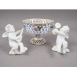 A Dresden pedestal dish with pierced and relief flower decoration, 3 1/2" high, and a pair of