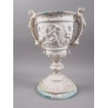 A 19th century cast and painted two-handled urn with cherub decoration, 12 3/4" high