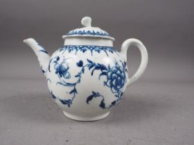 A mid 18th century Worcester blue and white globular teapot and cover with hand-painted floral