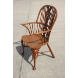 A Stewart Linford yew Windsor elbow chair with pierced splat and crinoline stretcher, on turned