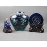 A Chinese early Ming style bulbous vase with figures in clouds decoration on a dark blue ground, 11"