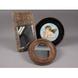 A barbola paste framed wall mirror with oval plate, 5 1/4" x 4 1/2", an embossed brass framed wall