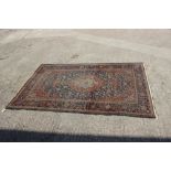A Kirman rug with all-over floral design on a blue ground, 75" x 50" approx