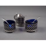 A pair of silver lattice salts with blue glass liners and a matching mustard pot, 1.25oz troy approx