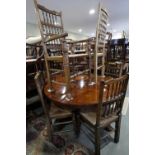 A set of six oak spindle back dining chairs with rush envelope seats, on turned and stretchered