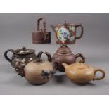 A Chinese Yixing teapot with relief floral decoration, 4 1/4" high, another similar and four other