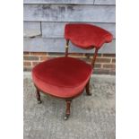 A Victorian low seat occasional chair/nursing chair, upholstered in a strawberry velour, on turned
