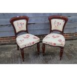 A set of six late Victorian mahogany showframe chairs with padded backs and stuffed over seats,