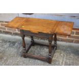 An oak draw leaf top stool, on turned and stretchered supports, 18" wide x 12" deep x 19" high