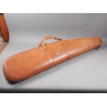 A Conway, London, tan leather rifle carry bag with textured sponge interior, 47 1/2" long, and a