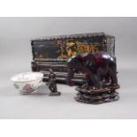 A Chinese lacquer box, a resin model of an elephant, on carved wood stand, a metal model of a