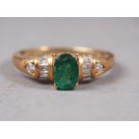 An 18ct gold diamond and emerald dress ring, size N, 3.2g