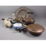 A 19th century cast iron dog nut crack, a copper kettle, an embossed brass charger, a pair of