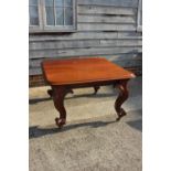 A Victorian carved mahogany extending dining table with two extra leaves, on cabriole scroll